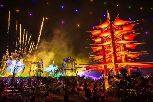 Headliners chill by a glowing art installation