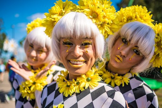 Three performers in daisies and harlequin patterns