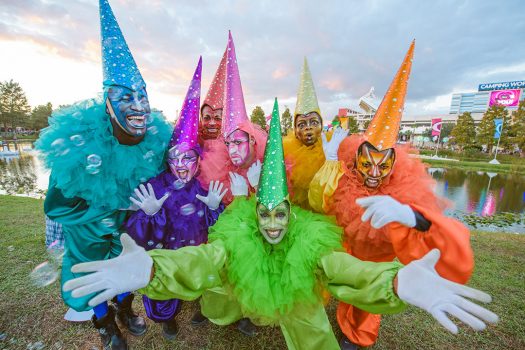 Colorful performers in pointy hats