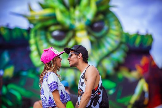 A couple kissing in front of kineticFIELD