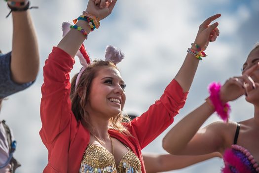 A girl in bunny ears with her hands in the air