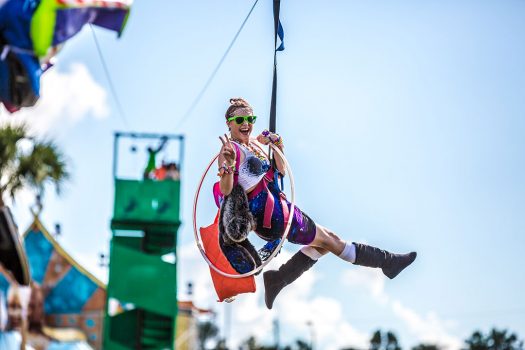 A Headliner with a hula hoop on a zip line