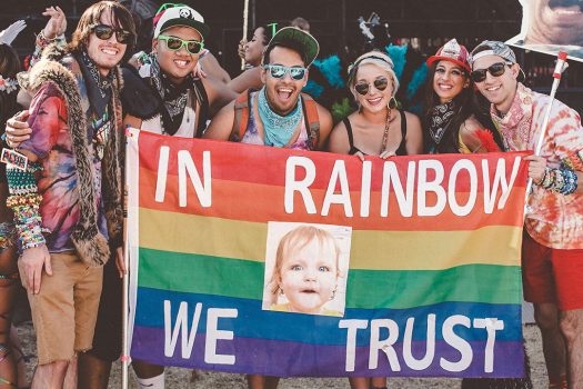 Headliners with an "In Rainbow We Trust" flag