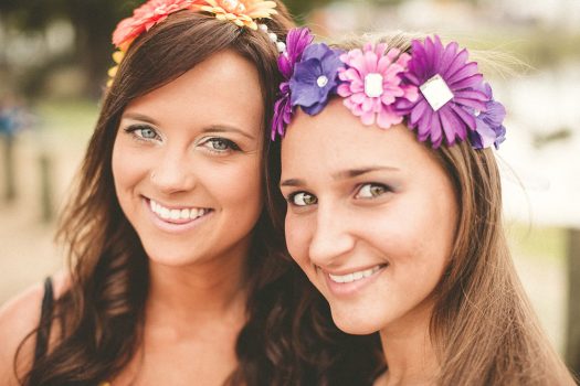 Two smiling girls with daisy headbands