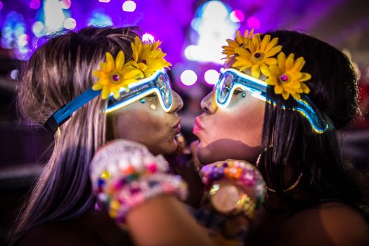 Girls in daisy headbands and glow glasses