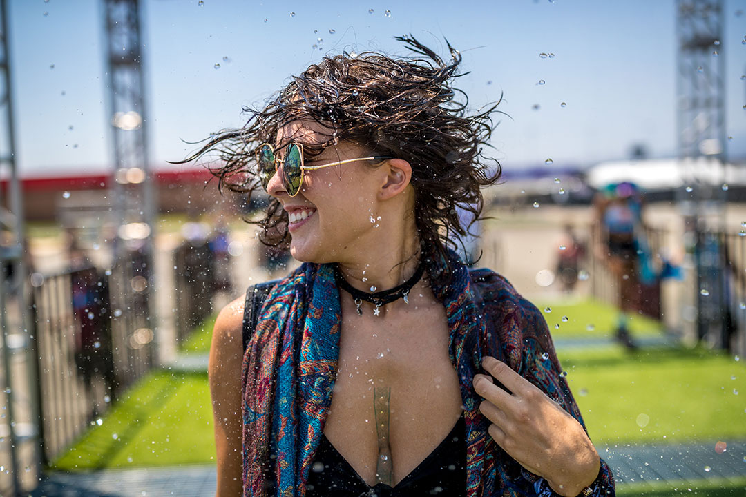 A woman shakes out her wet hair