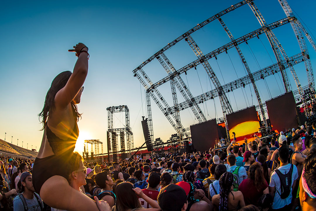 A woman watches the show from atop her friend's shoulders